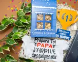 Un petit mot pour futur papa : un body "Papa j'arrive" et du popcorn pour célébrer l'heureux événement.