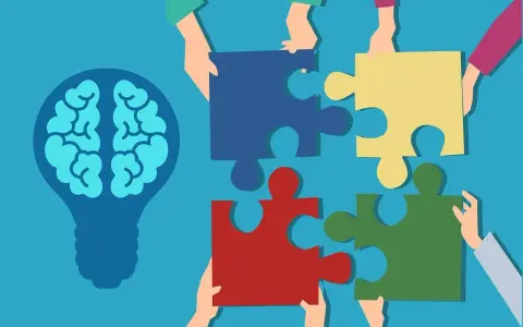 Des mains assemblent des pièces de puzzle autour d'une ampoule représentant un cerveau, symbolisant la compréhension de la déficience mentale légère chez l'adulte.