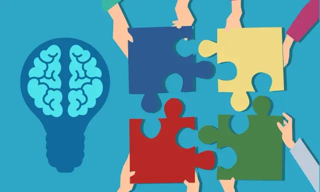 Des mains assemblent des pièces de puzzle autour d'une ampoule représentant un cerveau, symbolisant la compréhension de la déficience mentale légère chez l'adulte.